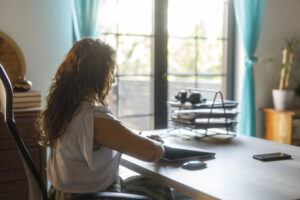 Woman sitting at her shared office desk